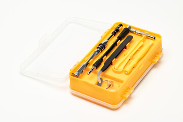 Parts of precision screwdriver tool kit in it's storage case. Isolated in white background.