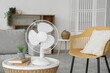 © Pixel-Shot - Modern electric fan on coffee table in living room