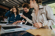 © qunica.com - Business colleagues experiencing a misunderstanding and arguing during a meeting at the office. Team members appear frustrated and stressed.