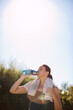 © STEEX/peopleimages.com - Mature, woman and fitness or drinking water outside in nature, hydration and health or outdoor workout goal. Sport, wellness athlete and training in summer for female person, runner and park or break