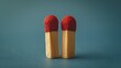 © MAY - Two identical matches standing upright, side by side, symbolizing a perfect match or compatibility.