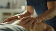 © VictorCanalesStudio - Close up of physical therapist massages a patient's back