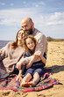 © DariaTrofimova - Sunny portrait of  loving family of parents and daughter with son on  beach by  sea
