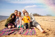 © DariaTrofimova - Sunny portrait of  loving family of parents and daughter with son on  beach by  sea
