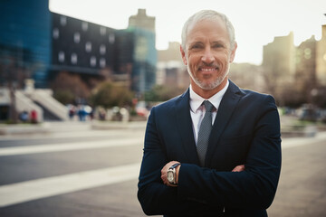 Wall Mural - Businessman, mature and arms crossed with portrait in city for business travel for commuting, downtown and outdoor for job. Male entrepreneur or lawyer, confident and happy for corporate career.