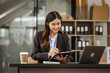 © M+Isolation+Photo - A young Asian businesswoman is seen diligently working at her desk. She's immersed in tasks ranging from recruitment and onboarding to performance management and diversity initiatives.