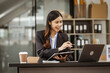 © M+Isolation+Photo - A young Asian businesswoman is seen diligently working at her desk. She's immersed in tasks ranging from recruitment and onboarding to performance management and diversity initiatives.