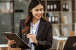 © M+Isolation+Photo - A young Asian businesswoman is seen diligently working at her desk. She's immersed in tasks ranging from recruitment and onboarding to performance management and diversity initiatives.