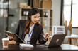 © M+Isolation+Photo - A young Asian businesswoman is seen diligently working at her desk. She's immersed in tasks ranging from recruitment and onboarding to performance management and diversity initiatives.