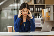 © M+Isolation+Photo - Young woman and other Asian individuals in formal suits work at desks with laptops, addressing concerns such as office syndrome, ergonomics, musculoskeletal disorders, and computer vision syndrome.