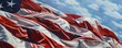 © Jasmine - Deliver a vibrant, photorealistic close-up image of an American flag rippling in the wind against a pristine blue sky backdrop Emphasize the fine details of the fabric and capture the essence of freed