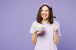 © ViDi Studio - Young calm woman wears pyjamas jam sleep eye mask rest relax at home eat breakfast muesli cereals with milk fruit in bowl look aside isolated on plain purple background. Good mood night nap concept.