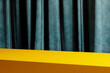 © hitdelight - Modern color background with yellow table top stage and blue velvet backdrop.