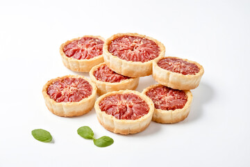 Wall Mural - Delicious Mini Grapefruit Tarts on White Background