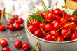 © Avocado_studio - Cherries. Fresh ripe cherries with leaves on a textured wooden background. Fresh sweet organic cherry pile. Berries and fruits. Vegan. Healthy eating. Place for text. Copy space