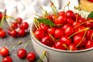 cherries. fresh ripe cherries with leaves on a textured wooden background. fresh sweet organic cherr