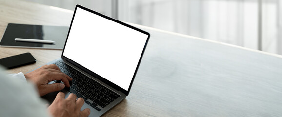 Wall Mural - businessman using computer with empty blank screen in office marketing and design background for adv
