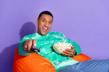 Poster - Photo of funky cool guy dressed turquoise sweatshirt enjoy pop corn watch movie isolated violet color background