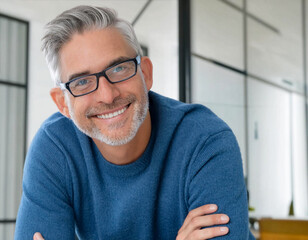 Portrait of smiling handsome man with grey hair and eyeglasses