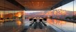© khwanchai - A contemporary lobby with floor-to-ceiling glass windows offering a panoramic view of the mountains, furnished with vibrant chairs and modern decor.