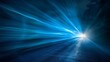 © tinnakorn - Abstract blue light streaks converging towards a bright white point in the distance, creating a sense of speed and movement.