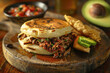 © acambium64 - Venezuelan Arepa Filled with Shredded Beef, Black Beans, and Cheese