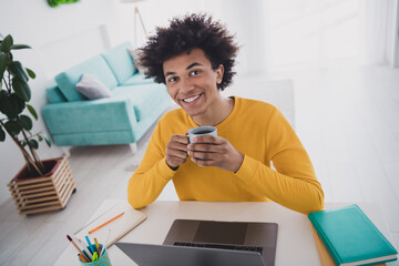 Poster - Photo of nice young man sitting table holding cup enjoying break comfort interior room indoors