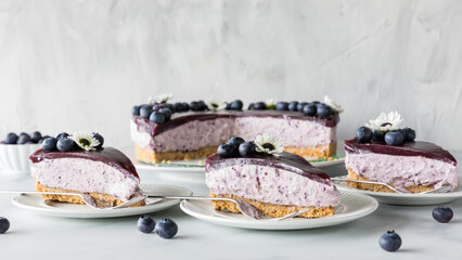 Three slices of fresh homemade blueberry cheesecake, ready for eating.