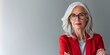 © inspiretta - a woman with glasses and a red jacket is posing for a picture with her arms crossed