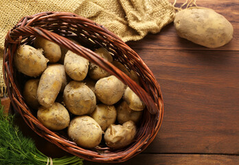 Wall Mural - raw organic potatoes on wooden table