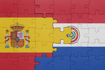 puzzle with the colourful national flag of paraguay and flag of spain.