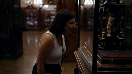 Wall Mural - Young beautiful hispanic woman looking at art exhibition at imperial treasure museum in Vienna