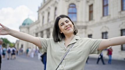 Poster - Young beautiful hispanic woman with open arms at Belvedere Palace in Vienna