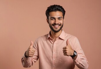 Wall Mural - A confident man with a full beard and a bright smile giving a thumbs up, against a peach backdrop.