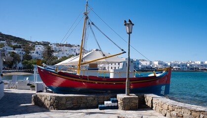 Sticker - Boat docked on a stone pier by the water