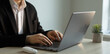 © Mer_Studio - Businessman working on laptop in a modern office.Businessman in a suit typing on  laptop keyboard.