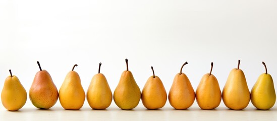 Fototapete - A scene showing ripe pears arranged neatly on a clean white surface with empty space for text or other elements in the image. with copy space image. Place for adding text or design