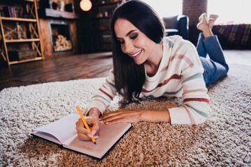 Poster - Photo of sweet adorable lady dressed striped jumper lying floor writing copybook indoors house room