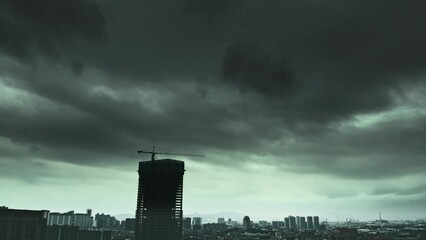 Wall Mural - Time lapse of dark clouds over a city