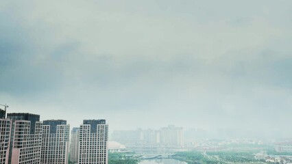 Wall Mural - Time lapse of dark clouds over a city