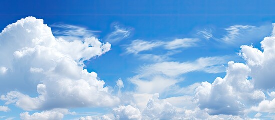 beautiful white fluffy clouds contrasted against a deep blue sky create a serene copy space image.