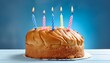 © Toby - fresh baked birthday cake with four candles blue back ground