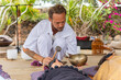 © ADDICTIVE STOCK - Healing sound therapy session with Tibetan bowls outdoors