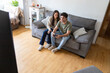 © ADDICTIVE STOCK - Happy young couple playing video games in cozy living room