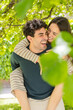 © ADDICTIVE STOCK - Joyful couple enjoying a playful moment in a lush garden