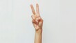 © Marco - hand of a woman making the peace sign on white background