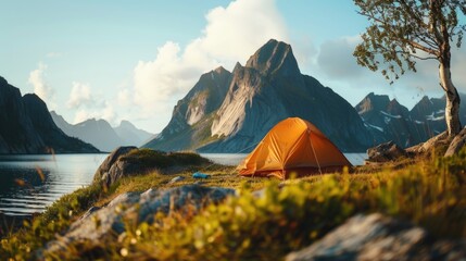 Wall Mural - A tent pitched at the edge of a mountain lake, surrounded by natural beauty