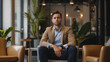 © Ali - businessman or entrepreneur sitting in modern office waiting for a meeting with CEO to raise funding for the startup