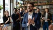 © Pro Hi-Res - Smiling businessman applauded by colleagues in modern office.