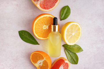 Wall Mural - Composition with bottle of essential oil and fresh citrus fruits on light background